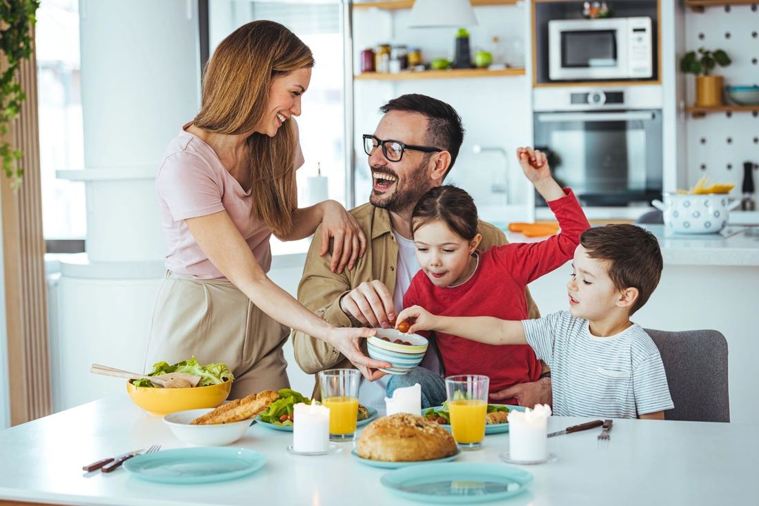 Family gathered around the kitchen counter in the morning